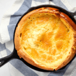 Golden cornbread cooked in a cast iron skillet.